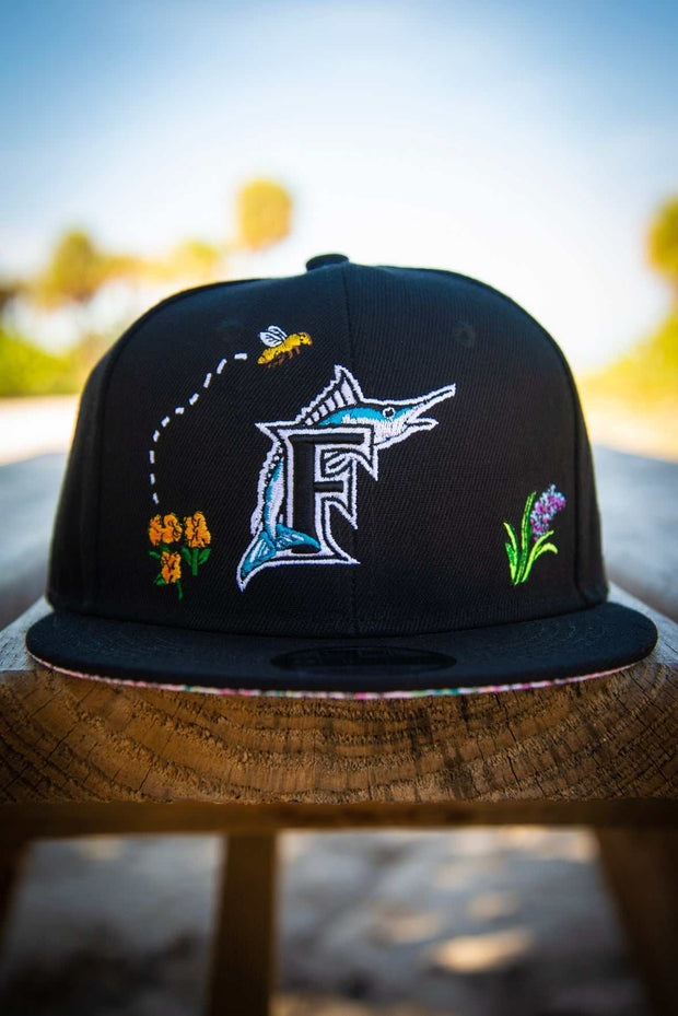 Miami Marlins Bee Spring Floral 9Fifty New Era Fits Snapback Hat New Era Fits Hats Miami Marlins Bee Spring Floral 9Fifty New Era Fits Snapback Hat Miami Marlins Bee Spring Floral 9Fifty New Era Fits Snapback Hat - Devious Elements Apparel